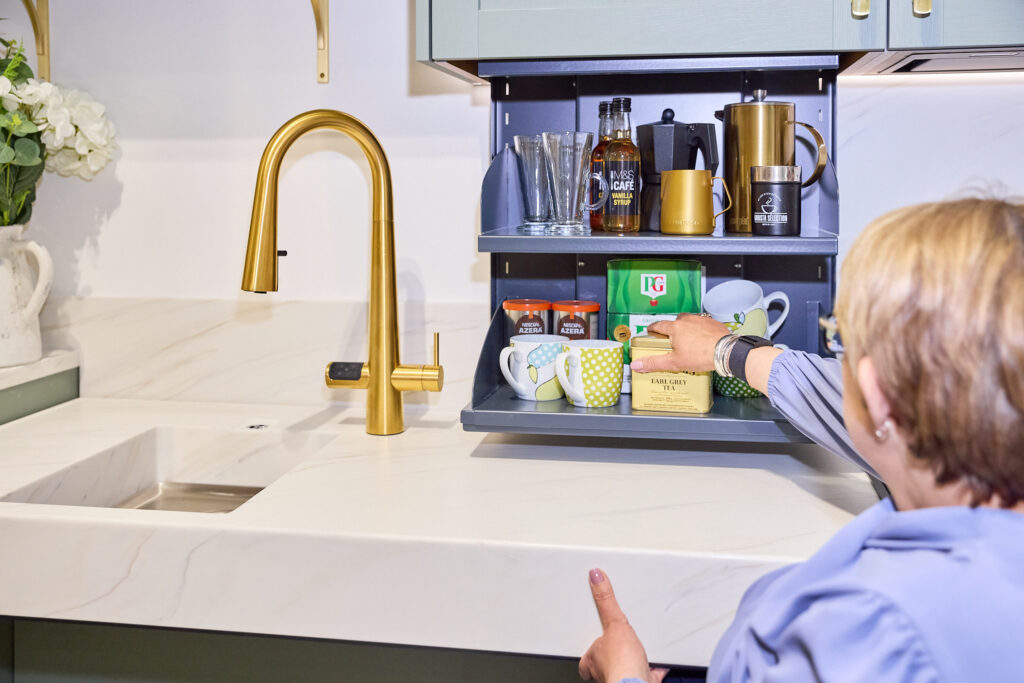 Tanni using the electric drop down wall cabinet