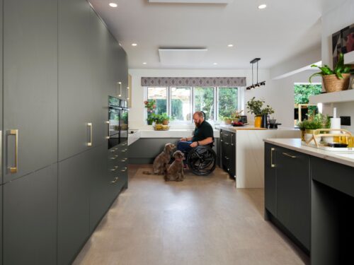 Ben with his dogs in his accessible kitchen